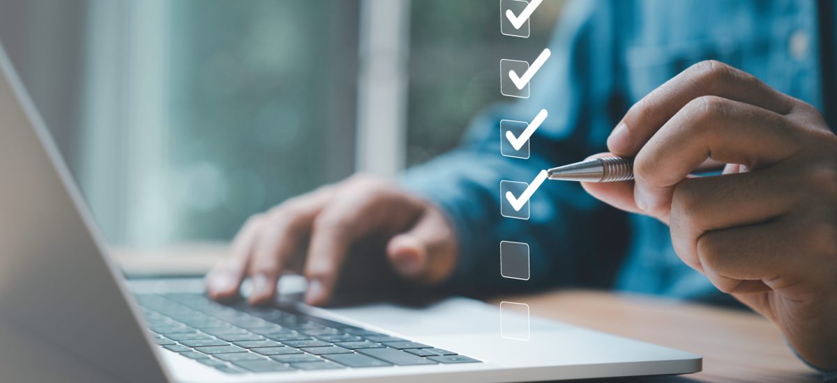 Businessman use pen to tick correct sign mark in checkbox for quality document control checklist and business approve project concept.